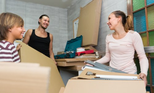 Home moving team handling boxes and furniture in Archway
