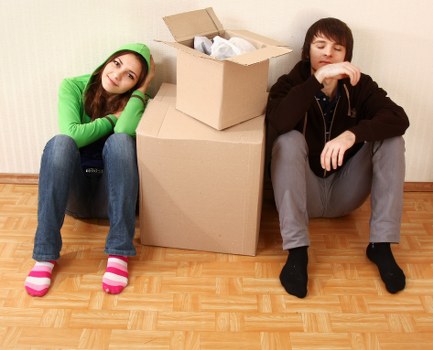 Packed moving boxes and furniture ready for transport in Archway