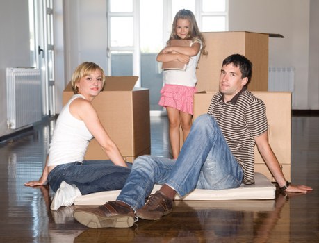 Movers carrying furniture through a narrow stairwell